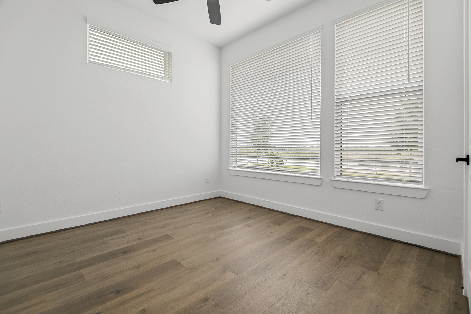 1809 Drover Lane Rosenberg, TX 77471 - Photo 12 of 21 an empty room with wooden floor and windows