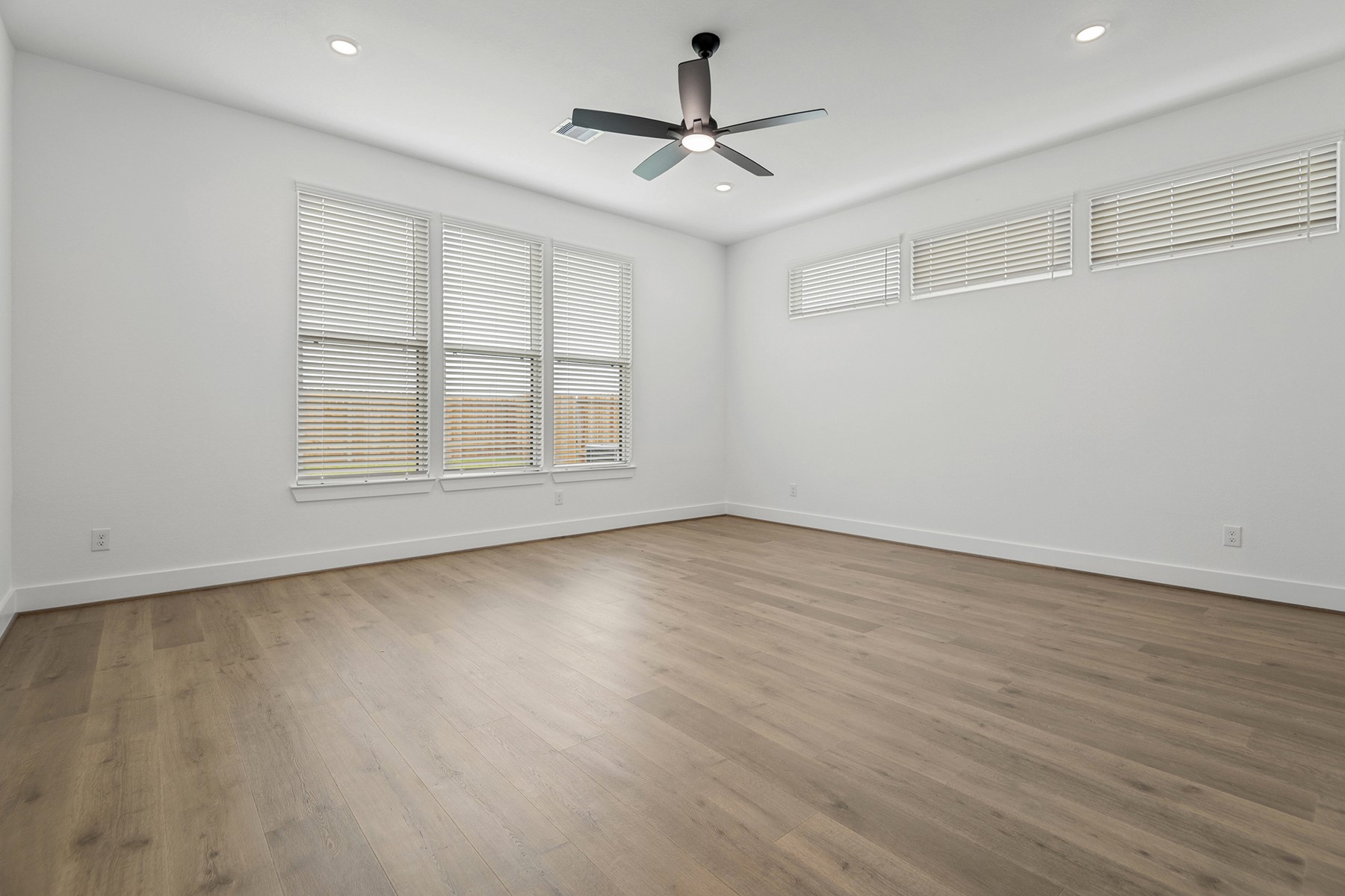 1809 Drover Lane Rosenberg, TX 77471 - Photo 13 of 21 an empty room with wooden floor and windows