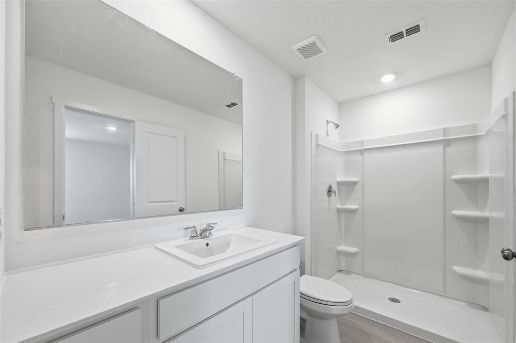 7709 Rutherford Lane McKinney, TX 75071 - Photo 11 of 23 a bathroom with a sink a toilet and shower