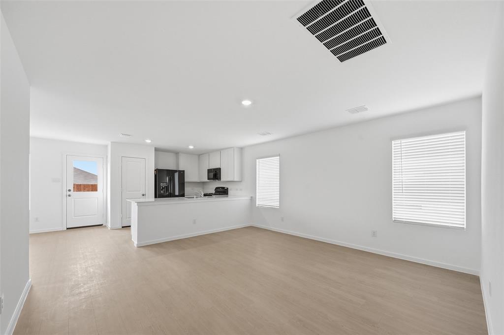 7709 Rutherford Lane McKinney, TX 75071 - Photo 3 of 23 a view of a kitchen with furniture and window