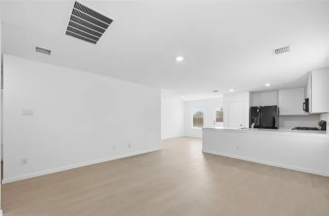a view of kitchen and livingroom with furniture