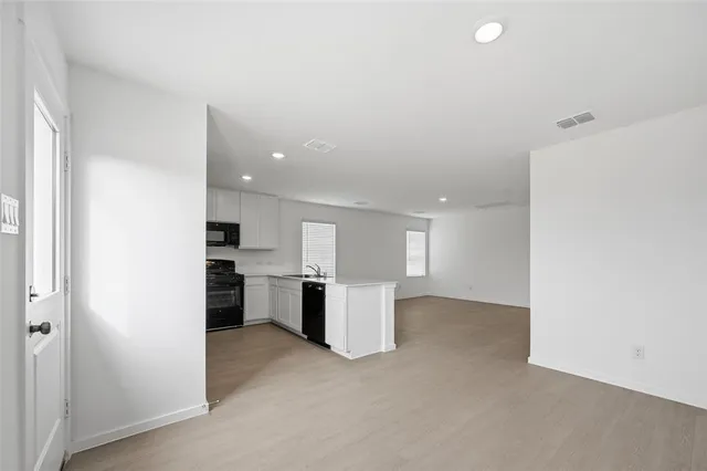 a view of a kitchen with a sink and a refrigerator