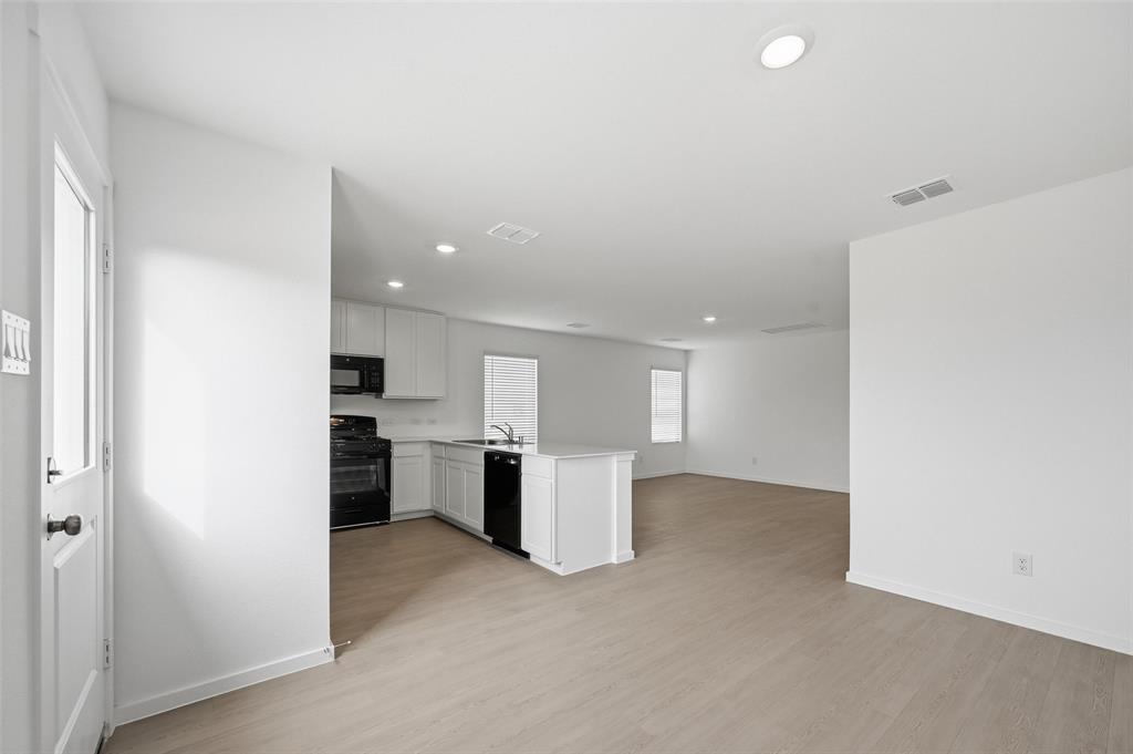 7709 Rutherford Lane McKinney, TX 75071 - Photo 5 of 23 a view of a kitchen with a sink and a refrigerator