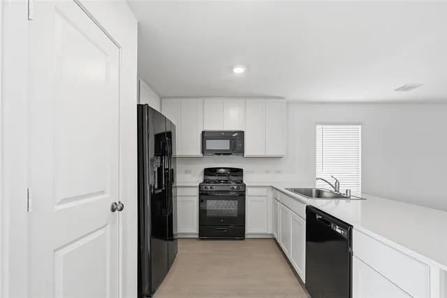 a kitchen with a refrigerator stove and oven
