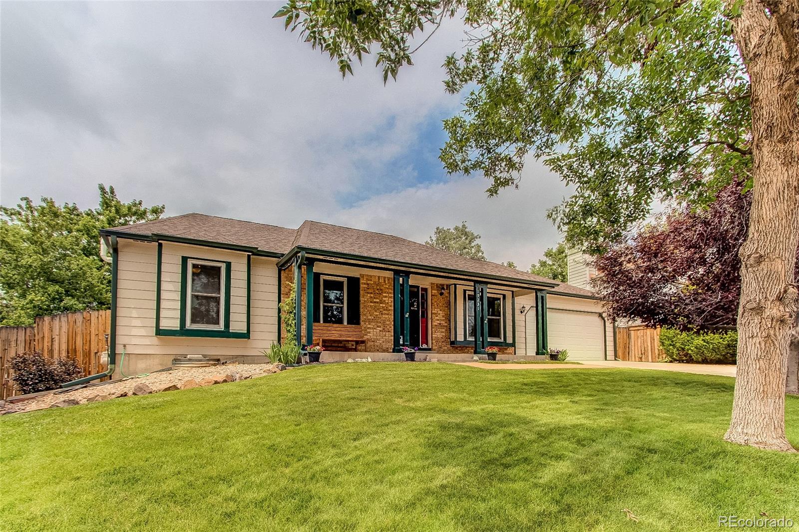 a front view of house with yard and green space