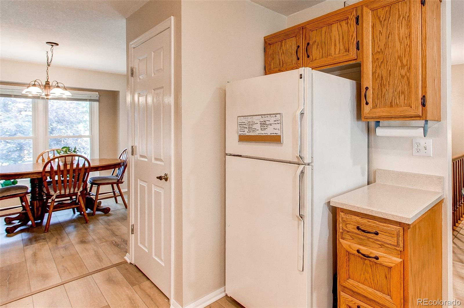 19231 East Rice Drive Aurora, CO 80015 - Photo 12 of 40 a white refrigerator freezer sitting in a kitchen
