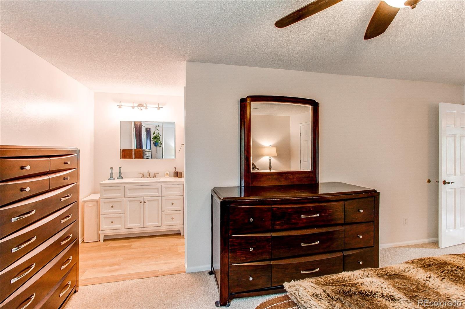 19231 East Rice Drive Aurora, CO 80015 - Photo 15 of 40 a bedroom with a bed and a dresser