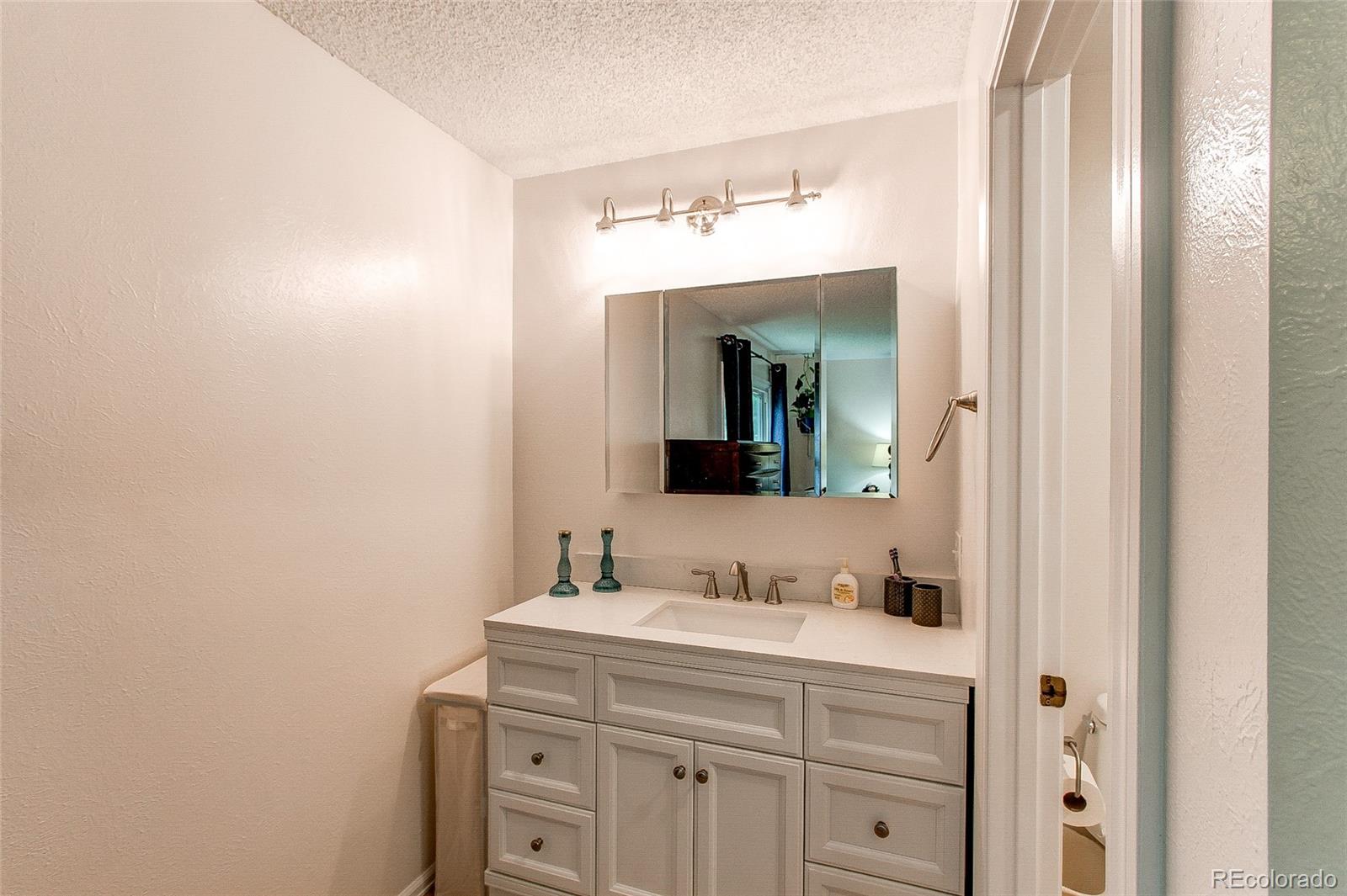 19231 East Rice Drive Aurora, CO 80015 - Photo 16 of 40 a bathroom with a sink and a mirror