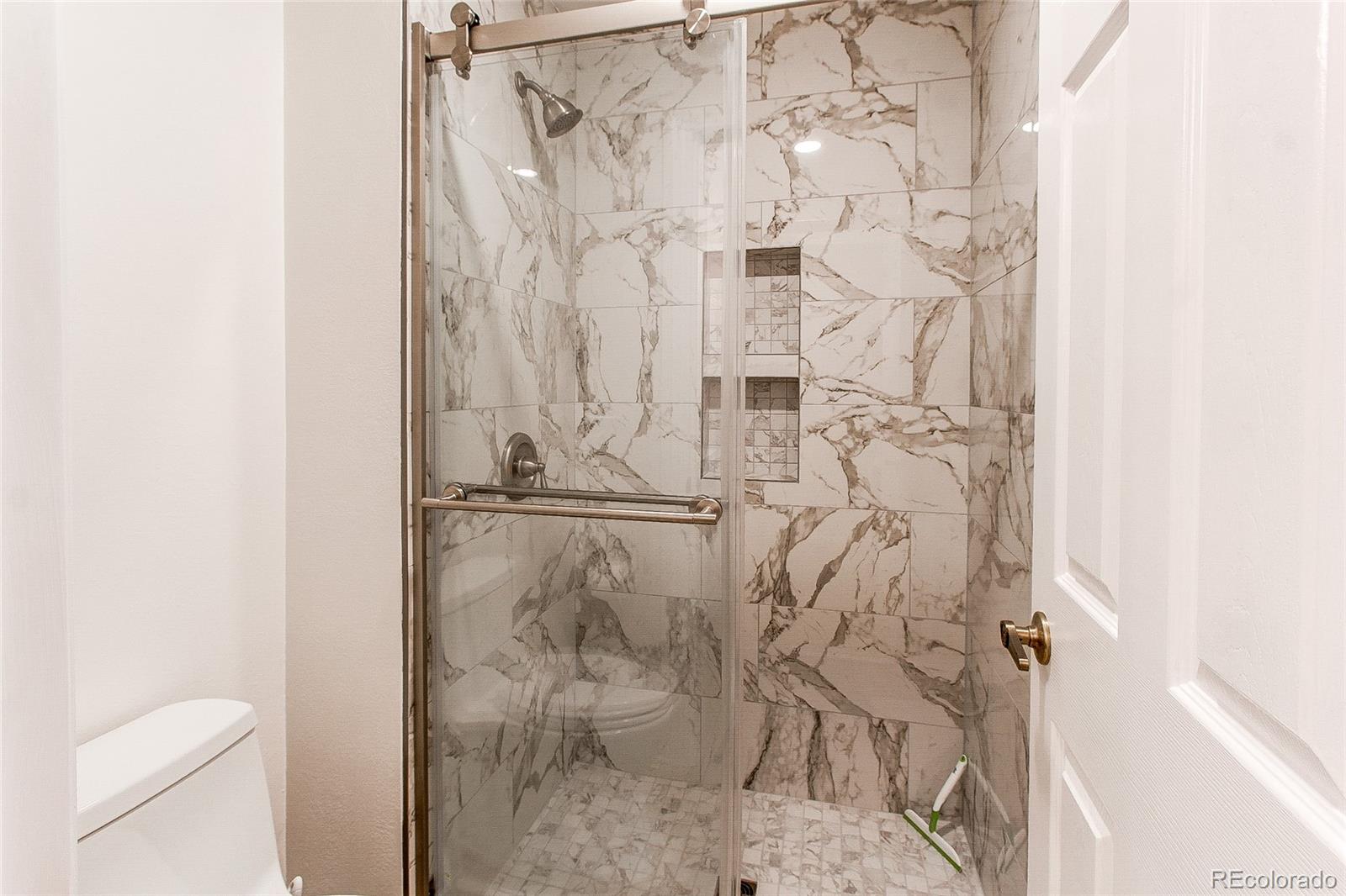 19231 East Rice Drive Aurora, CO 80015 - Photo 17 of 40 a bathroom with a shower and toilet