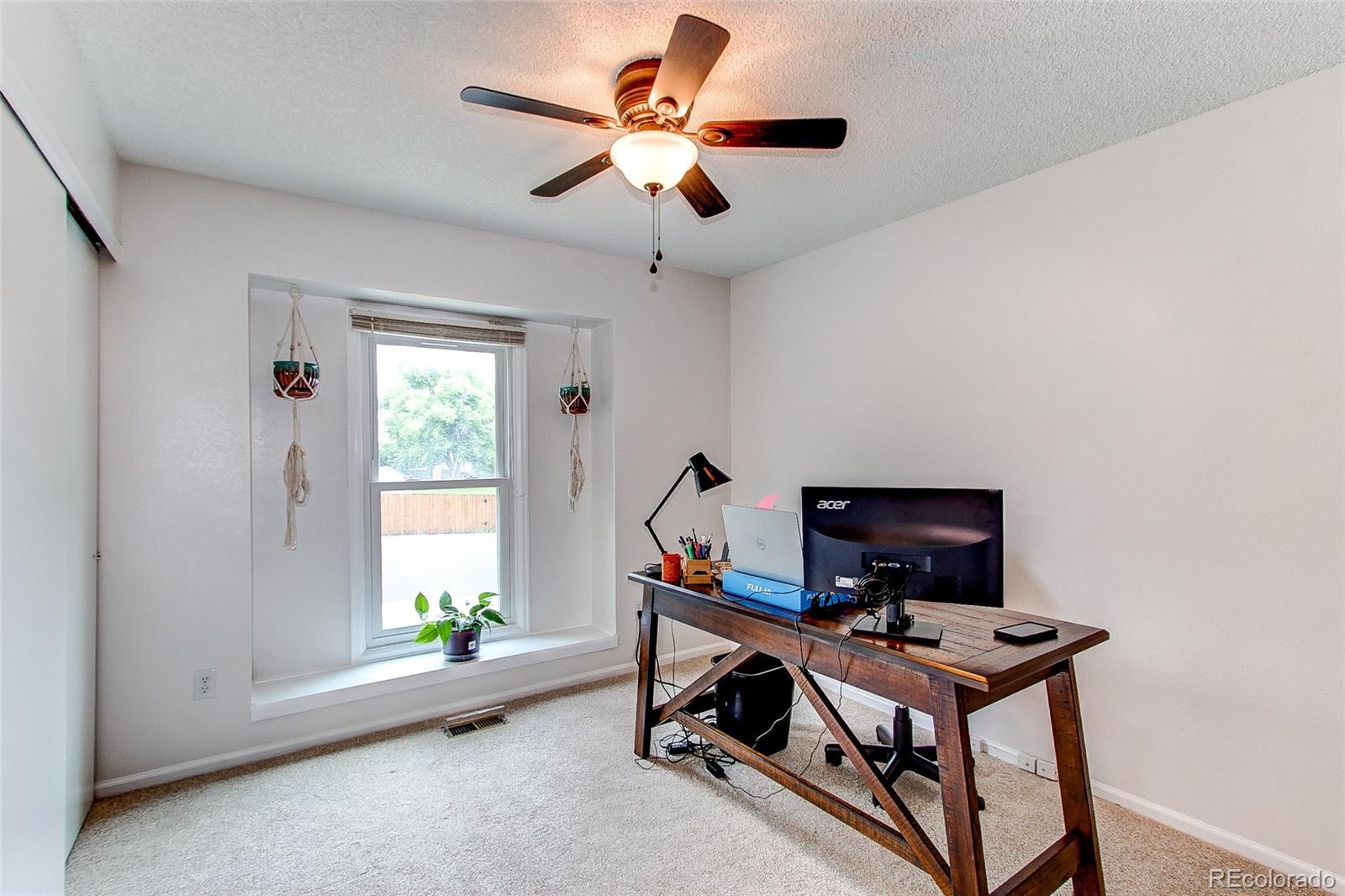 19231 East Rice Drive Aurora, CO 80015 - Photo 18 of 40 a room with furniture and a window