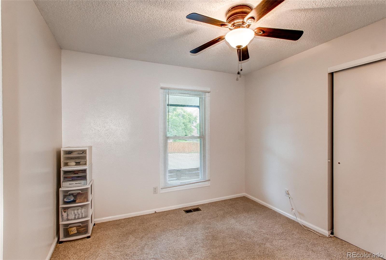 19231 East Rice Drive Aurora, CO 80015 - Photo 20 of 40 an empty room with windows and fan