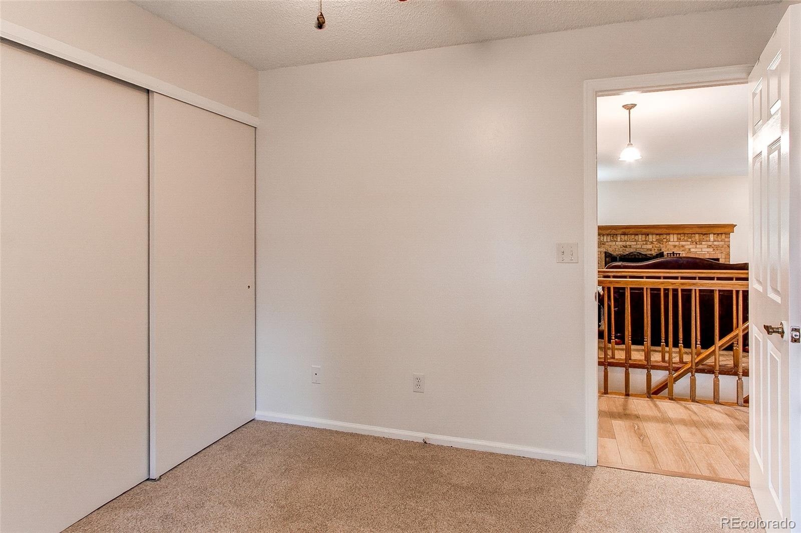 19231 East Rice Drive Aurora, CO 80015 - Photo 21 of 40 an empty room with sliding door