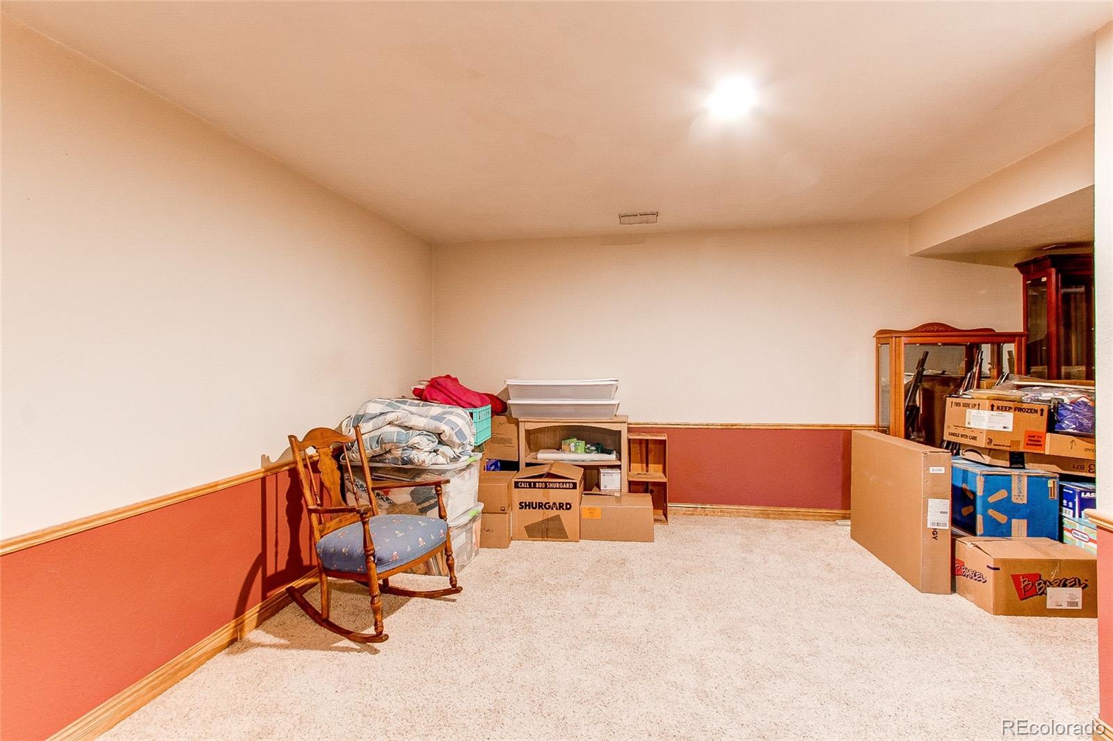 19231 East Rice Drive Aurora, CO 80015 - Photo 23 of 40 a workspace with furniture and a book shelf