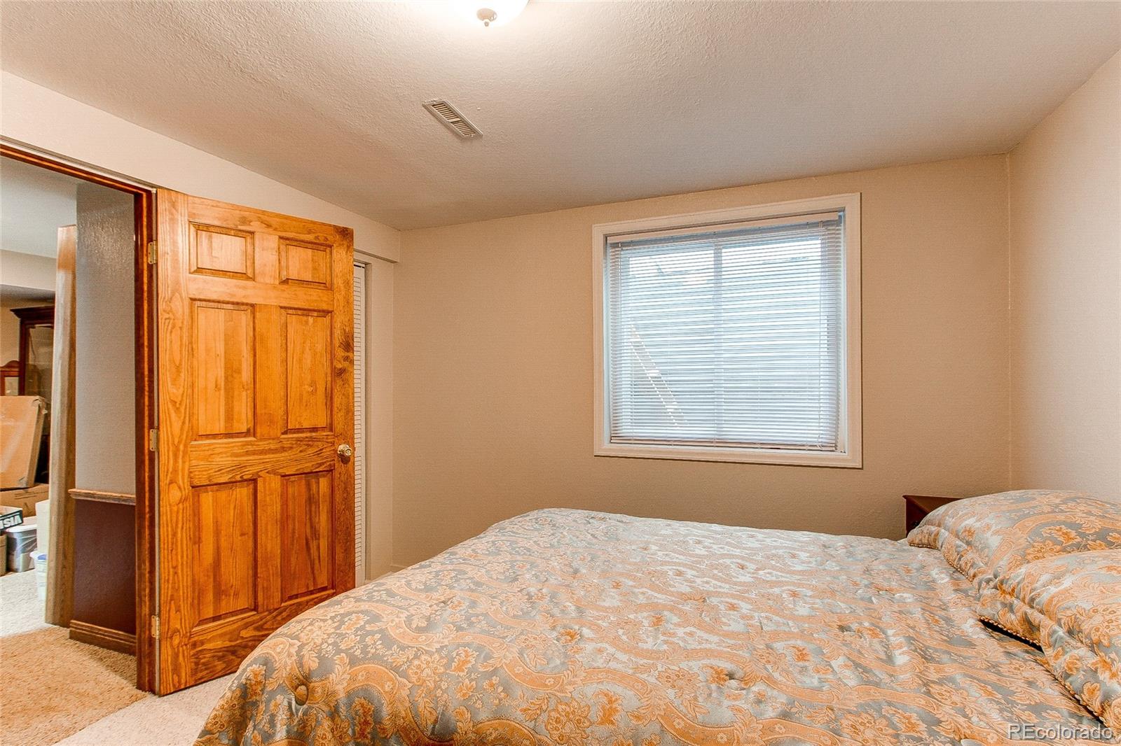 19231 East Rice Drive Aurora, CO 80015 - Photo 28 of 40 a bedroom with a bed and a window