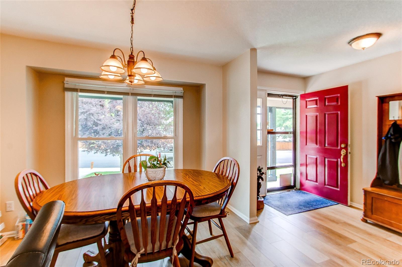 19231 East Rice Drive Aurora, CO 80015 - Photo 3 of 40 a view of a dining room with furniture window and wooden floor