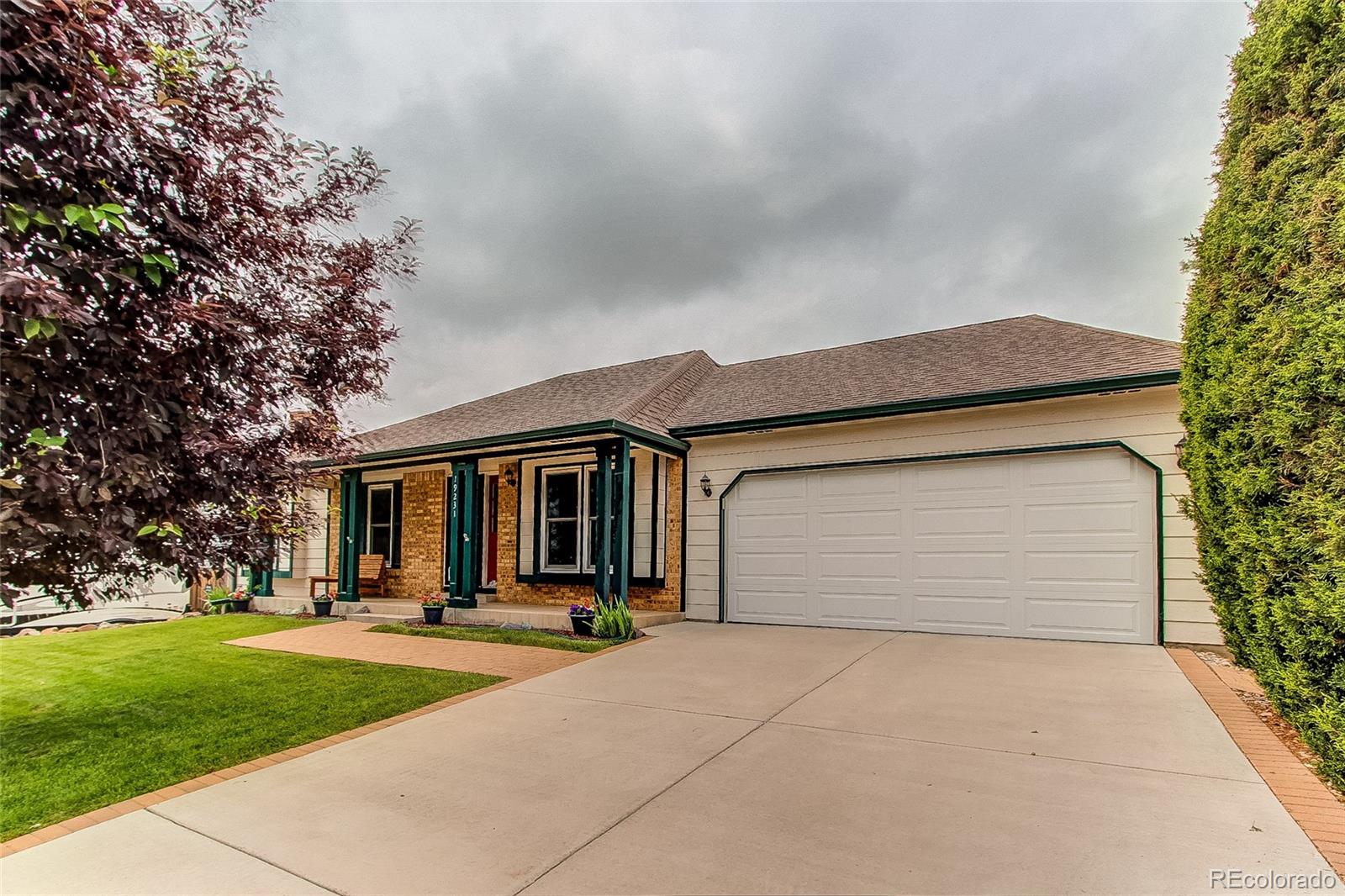 19231 East Rice Drive Aurora, CO 80015 - Photo 40 of 40 a front view of house with yard and garage