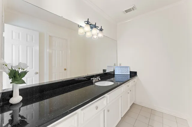 a kitchen with a sink and chandelier
