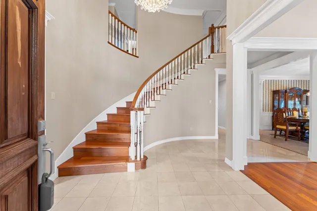 a view of entryway and hall with wooden floor