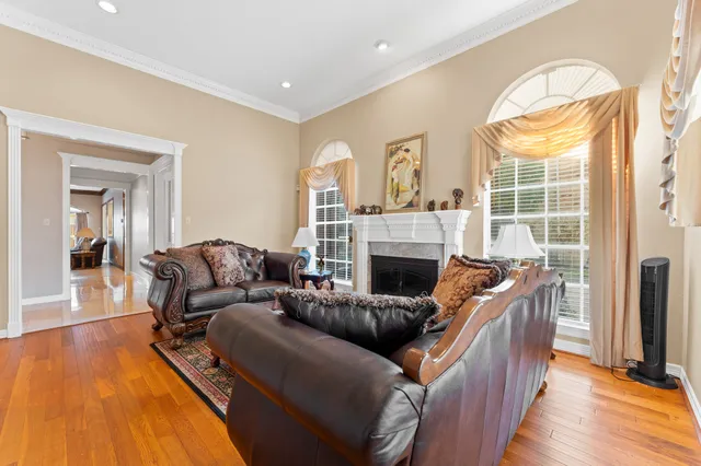a living room with furniture a fireplace and a flat screen tv