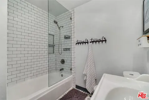 a bathroom with a bathtub and shower