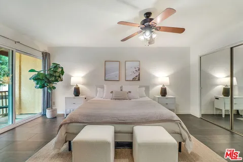 a view of a dining room with furniture and a chandelier fan