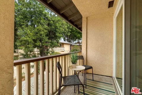 a view of a balcony with furniture