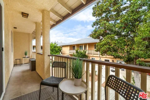 a view of a balcony with chairs
