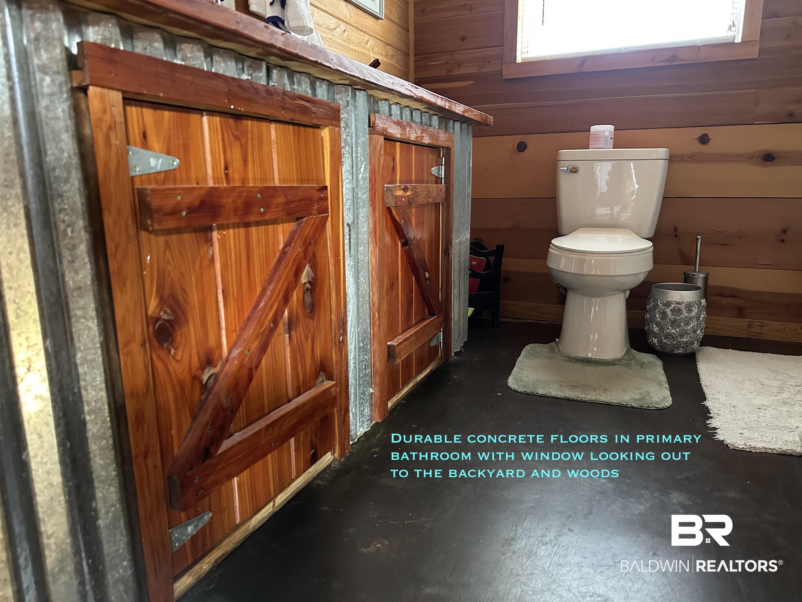 2772 Ramah Road Evergreen, AL 36401 - Photo 7 of 12 Bathroom featuring wooden walls and toilet