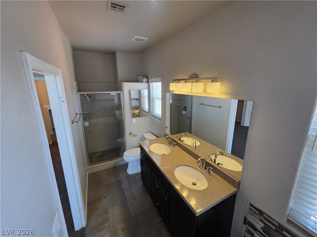 2275 Ramsgate Drive Henderson, NV 89074 - Photo 61 of 84 Granite counters and a spacious double vanity elevate this contemporary bathroom with a walk-in shower.