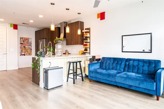 a living room with furniture and kitchen view