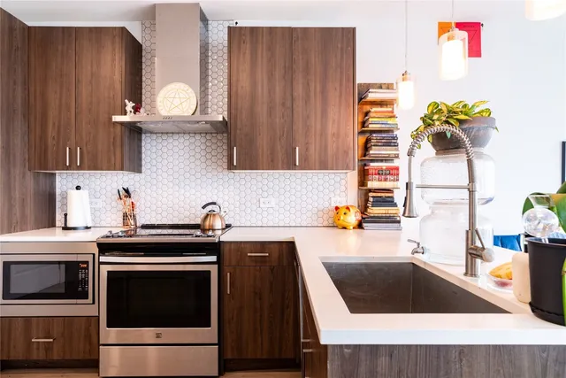 a kitchen with granite countertop a stove and a sink
