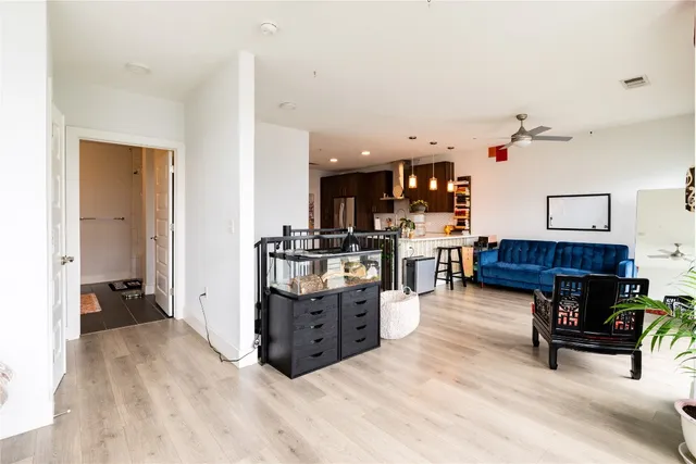 a living room with furniture and kitchen area