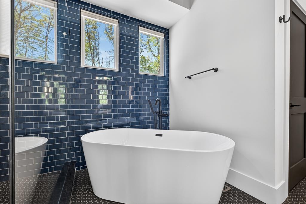 315 Blue Berry Ridge Morganton, GA 30560 - Photo 29 of 61 a white bath tub sitting in a bathroom next to a window
