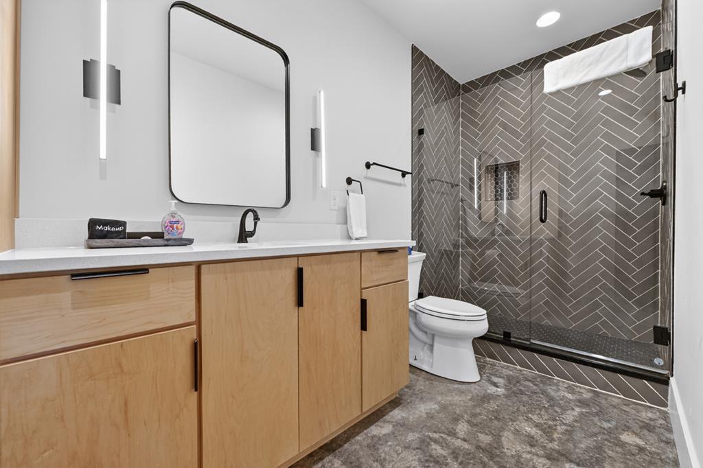 315 Blue Berry Ridge Morganton, GA 30560 - Photo 44 of 61 a bathroom with a granite countertop toilet sink and mirror