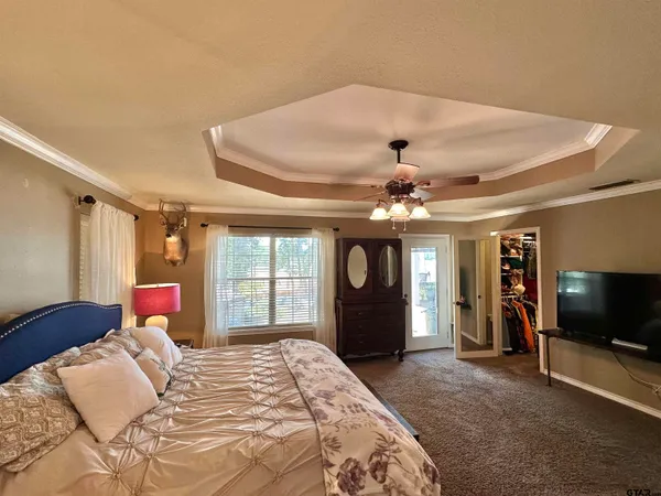 a bedroom with furniture and a flat screen tv