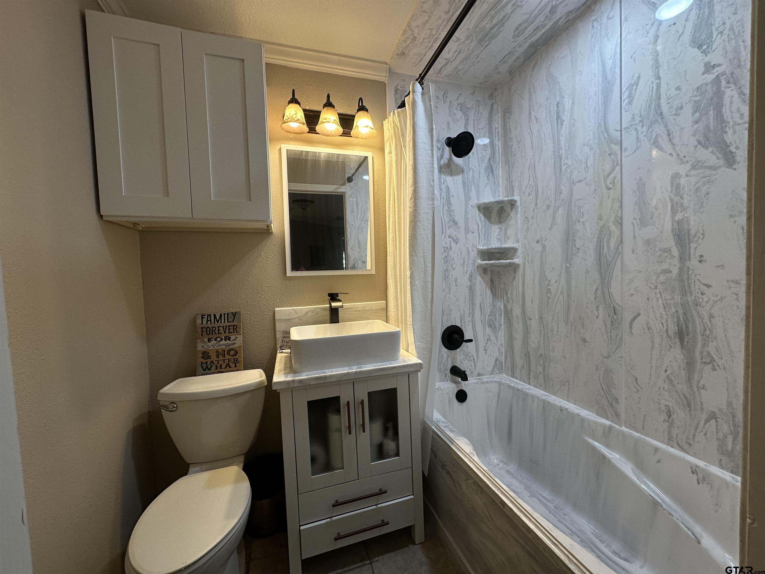 13449 South Hillcreek Road Whitehouse, TX 75791 - Photo 24 of 41 a bathroom with a toilet sink and mirror