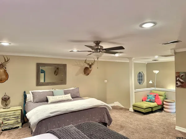 a bedroom with a bed and a mirror