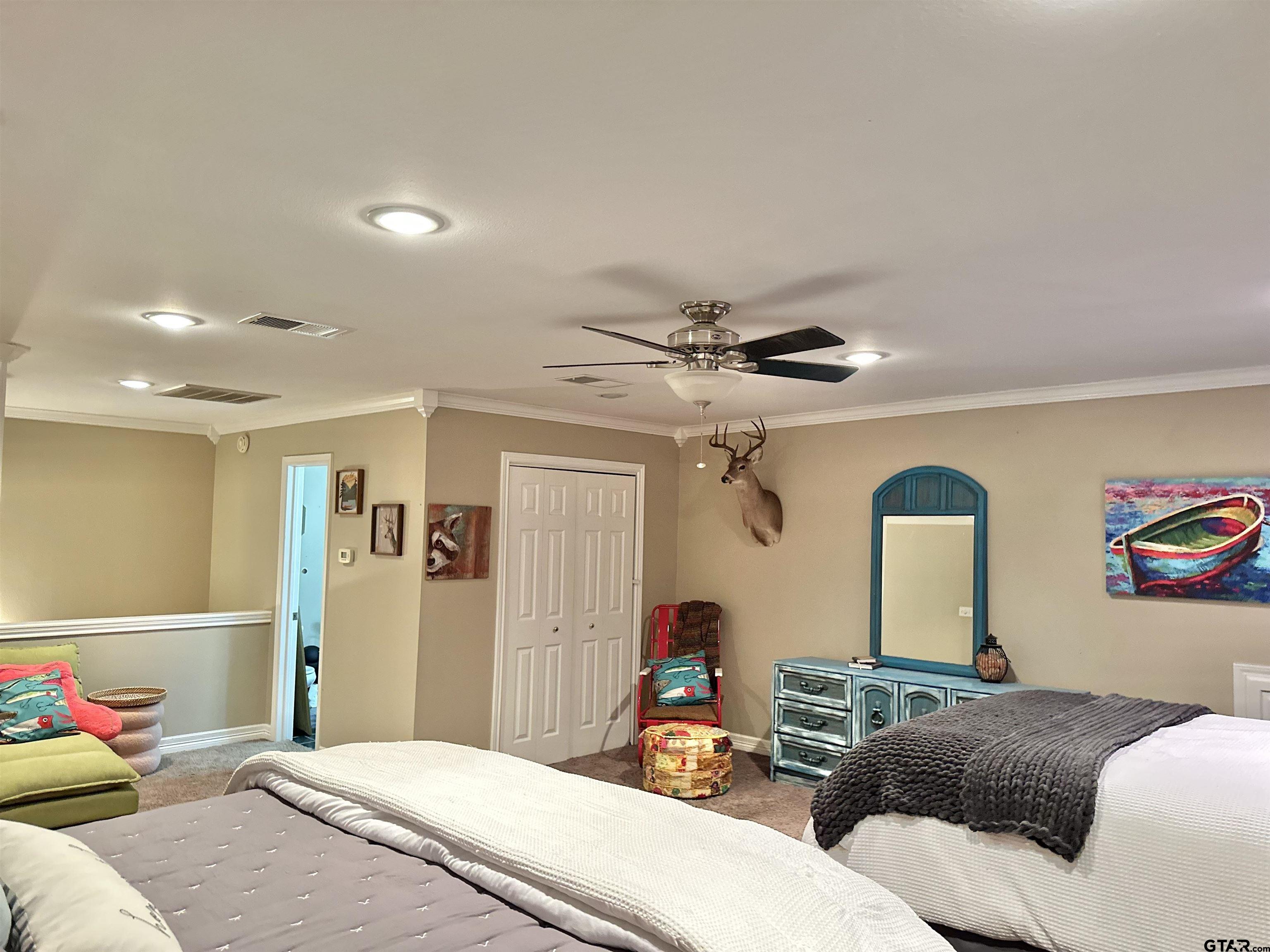 13449 South Hillcreek Road Whitehouse, TX 75791 - Photo 30 of 41 a bedroom with a bed and a chandelier