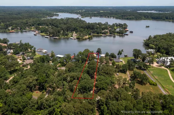 an aerial view of ocean and residential houses with outdoor space