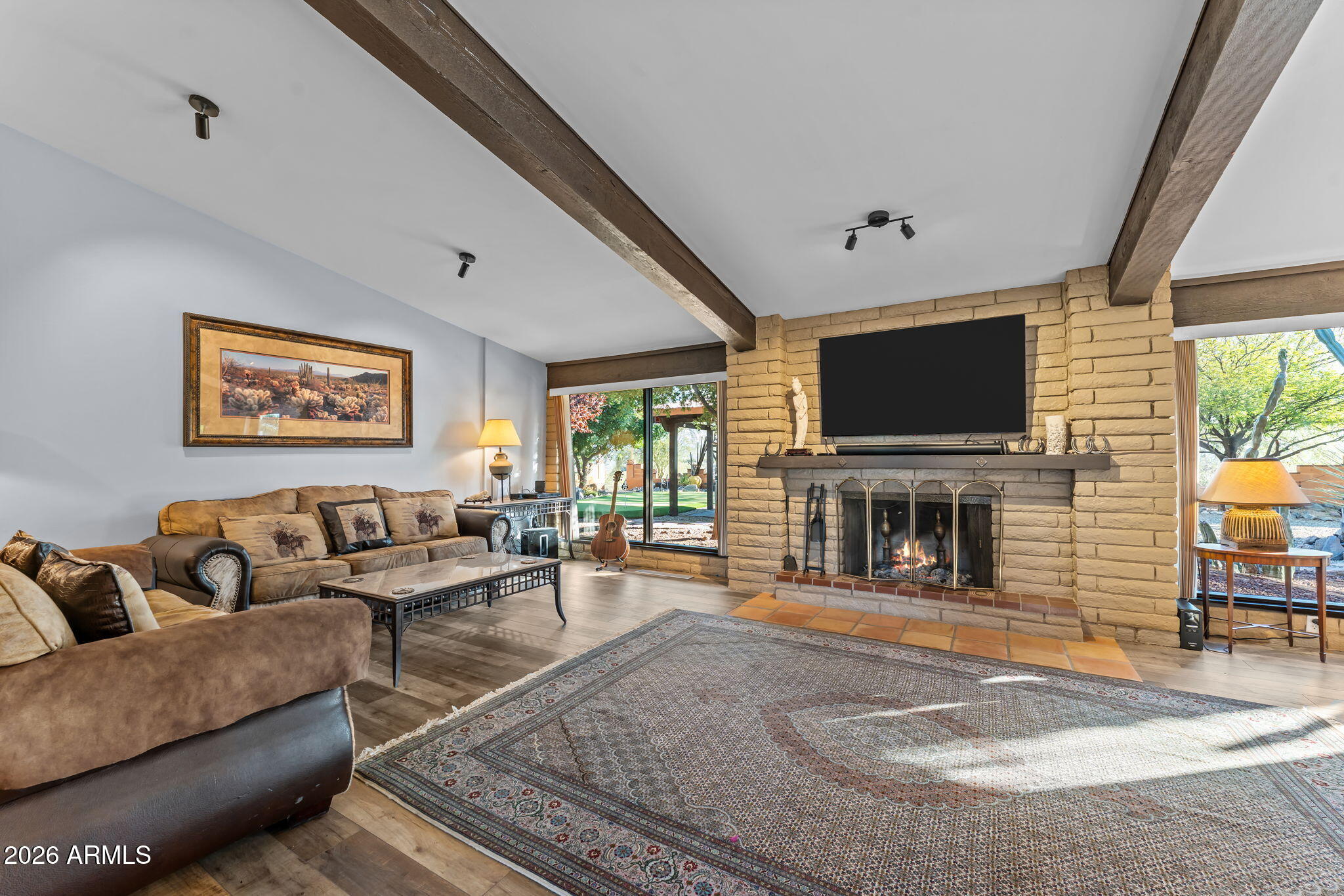 1349 North Forty Road Wickenburg, AZ 85390 - Photo 12 of 49 a living room with fireplace furniture and a flat screen tv