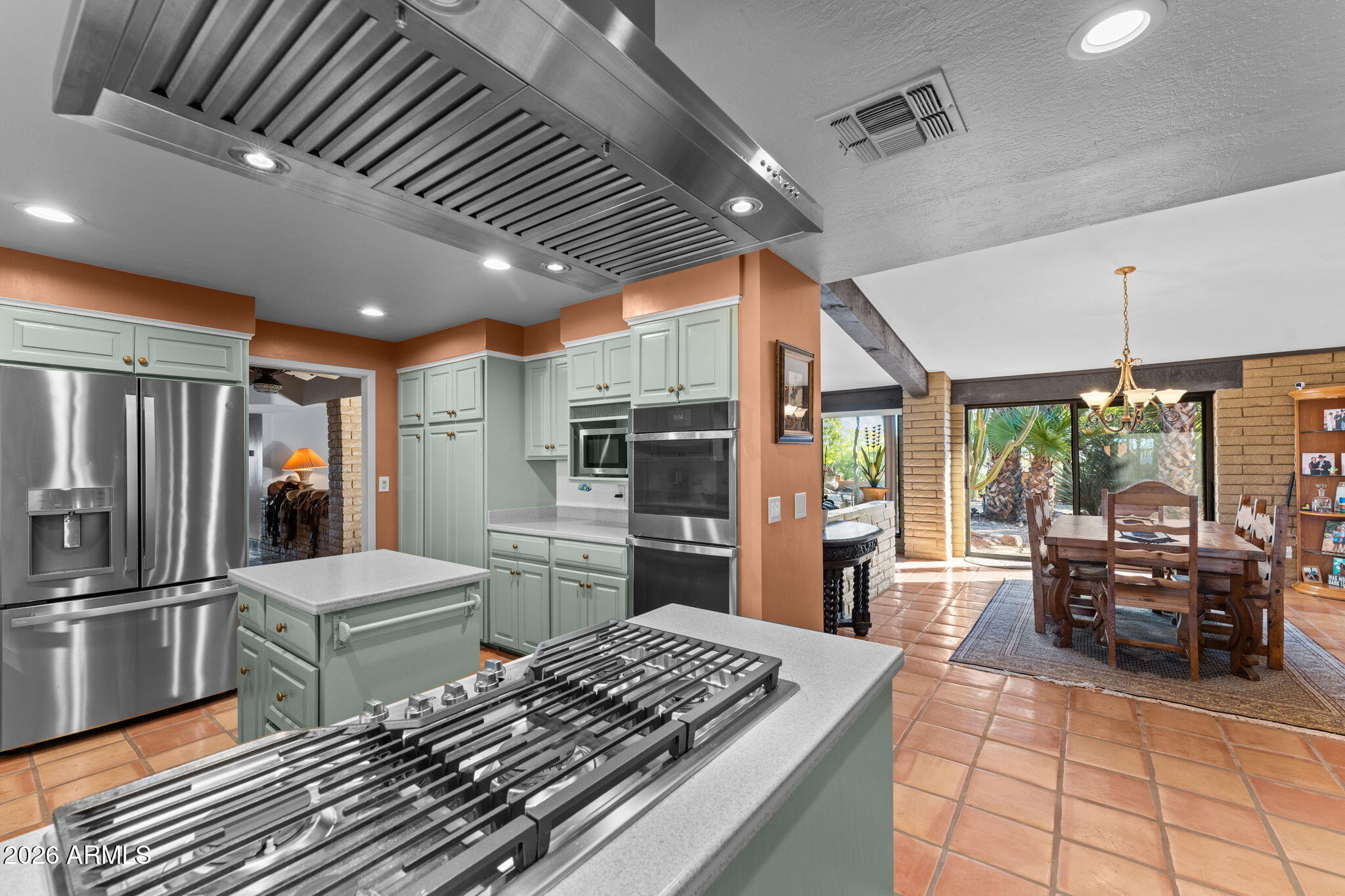 1349 North Forty Road Wickenburg, AZ 85390 - Photo 19 of 49 a kitchen with stainless steel appliances kitchen island granite countertop a refrigerator and microwave