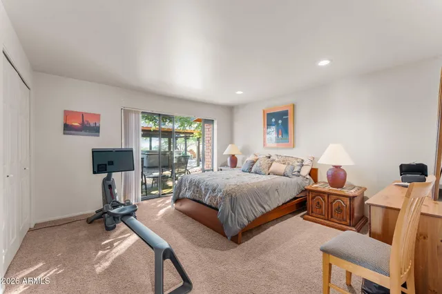 a kitchen with stainless steel appliances a refrigerator a stove a sink a dining table and chairs