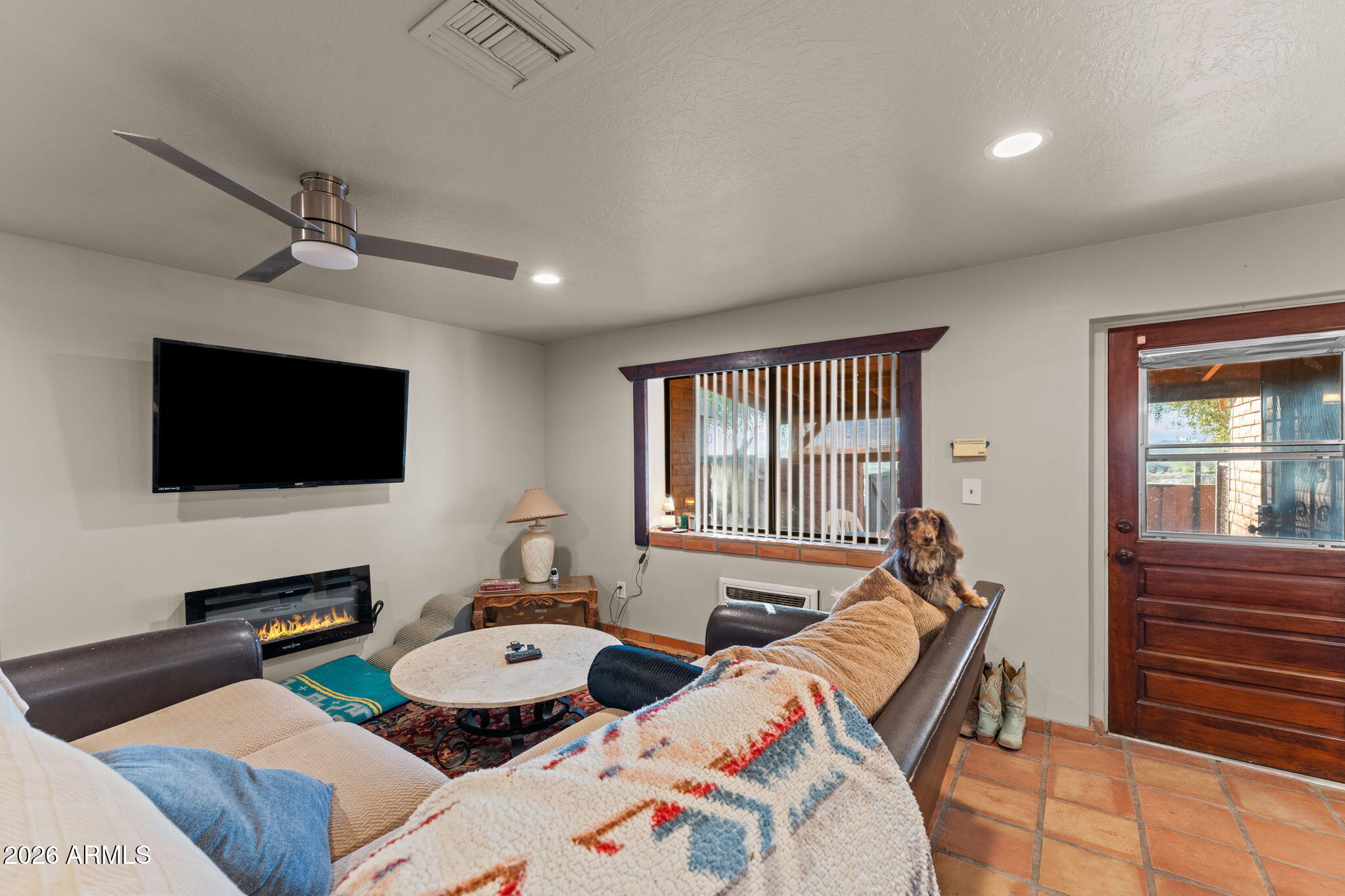 1349 North Forty Road Wickenburg, AZ 85390 - Photo 28 of 49 a living room with furniture and a flat screen tv