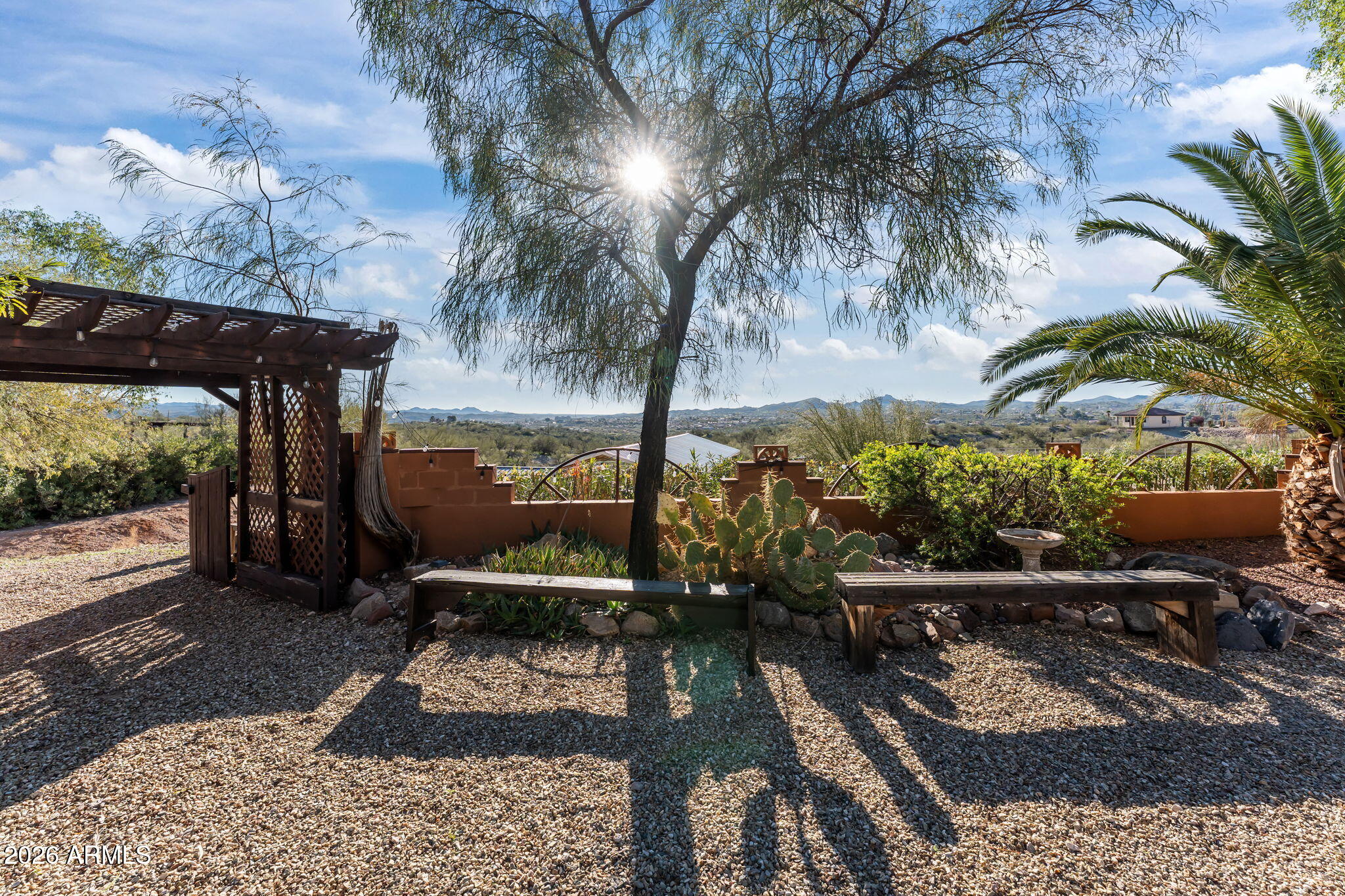 1349 North Forty Road Wickenburg, AZ 85390 - Photo 33 of 49 a view of a patio with table and chairs with wooden floor and fence