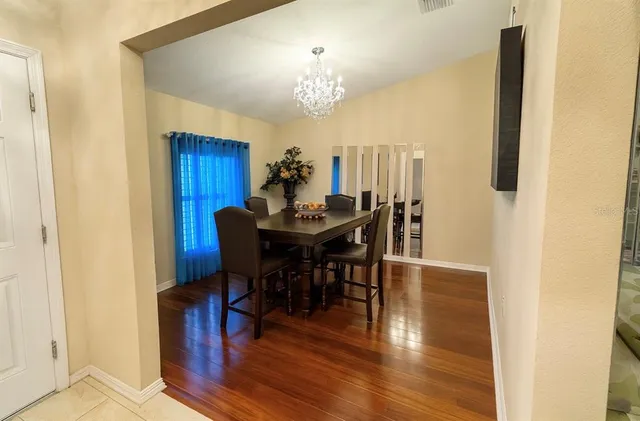 a view of a dining room with furniture and chandelier