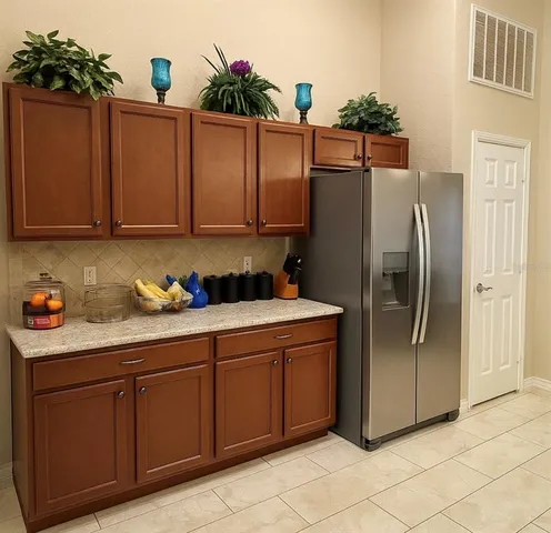 a kitchen with stainless steel appliances granite countertop a refrigerator and a stove