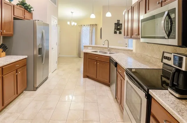 a kitchen with a sink stove and refrigerator
