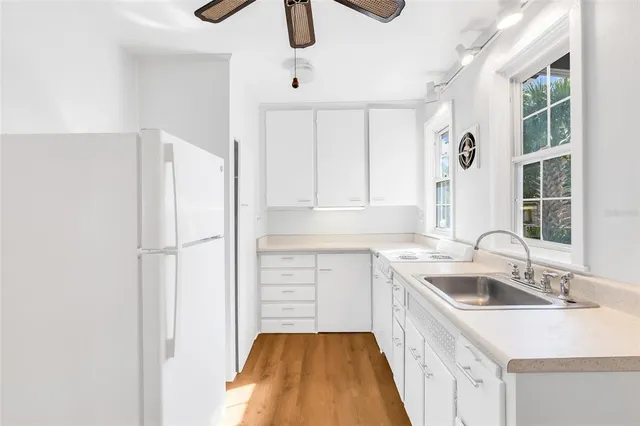 a kitchen with a sink and a refrigerator