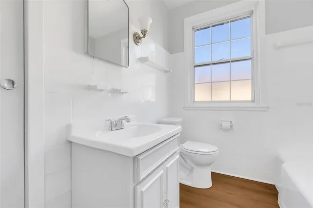 a bathroom with a sink toilet and a window