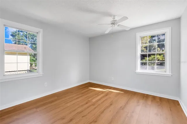 a view of a room with wooden floor and a window